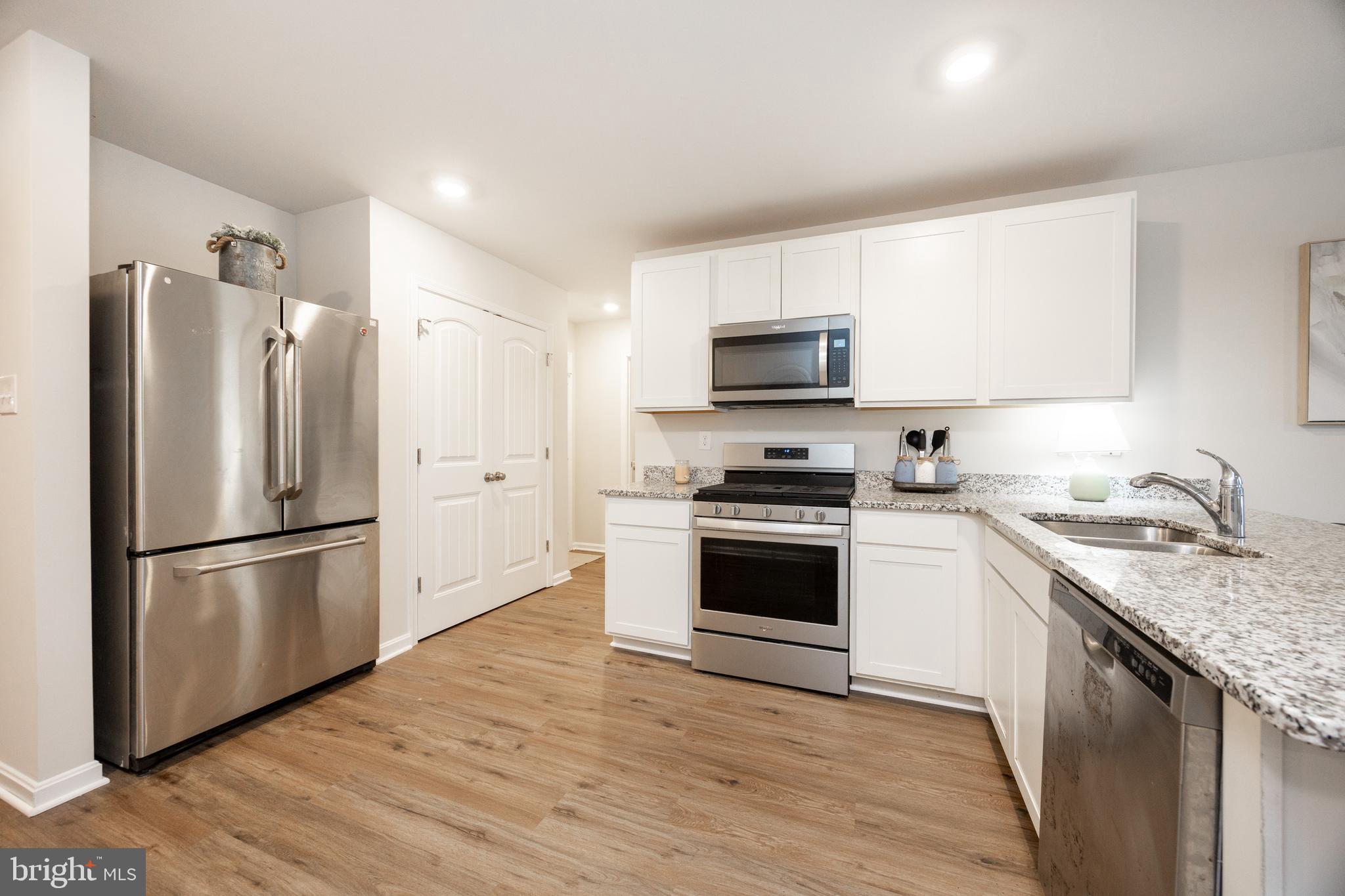 21 Clipper Street Smyrna, DE 19977 - Photo 12 of 39 a kitchen with a refrigerator stove and wooden floor