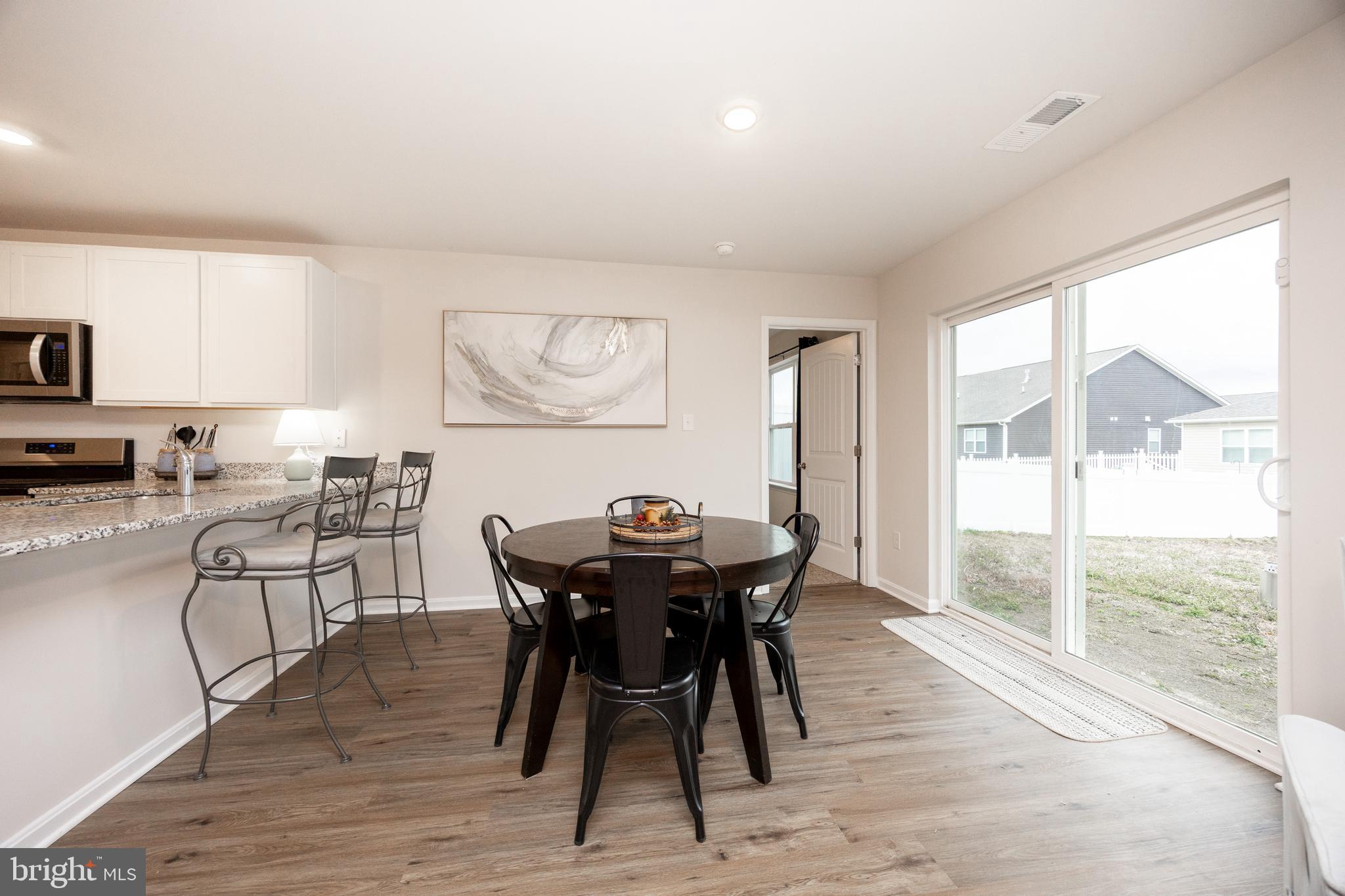 21 Clipper Street Smyrna, DE 19977 - Photo 14 of 39 a view of a dining room with furniture window and wooden floor