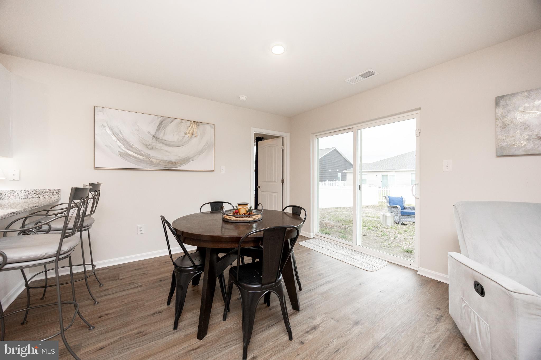 21 Clipper Street Smyrna, DE 19977 - Photo 15 of 39 a view of a dining room with furniture and wooden floor
