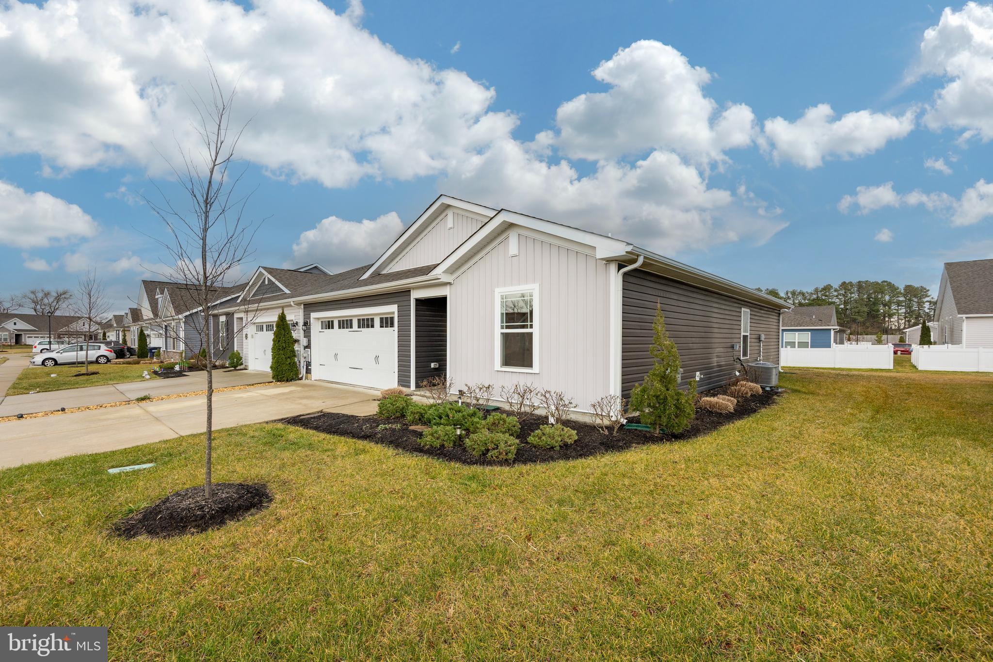 21 Clipper Street Smyrna, DE 19977 - Photo 34 of 39 a view of a white house next to a yard with big trees