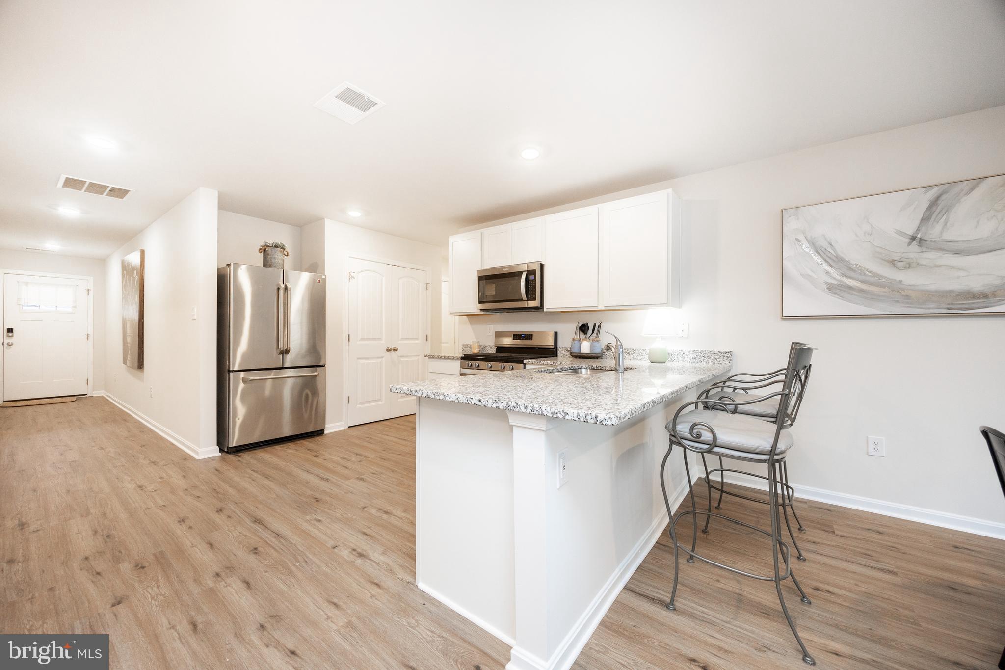 21 Clipper Street Smyrna, DE 19977 - Photo 10 of 39 a kitchen with stainless steel appliances granite countertop a stove a sink a refrigerator and a microwave
