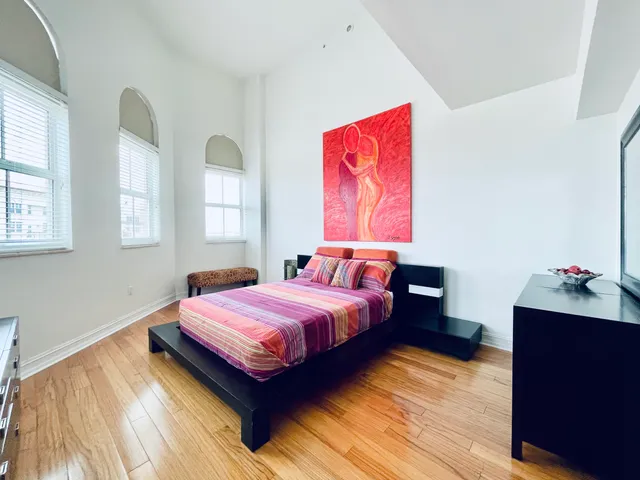 a living room with two bed furniture and a window