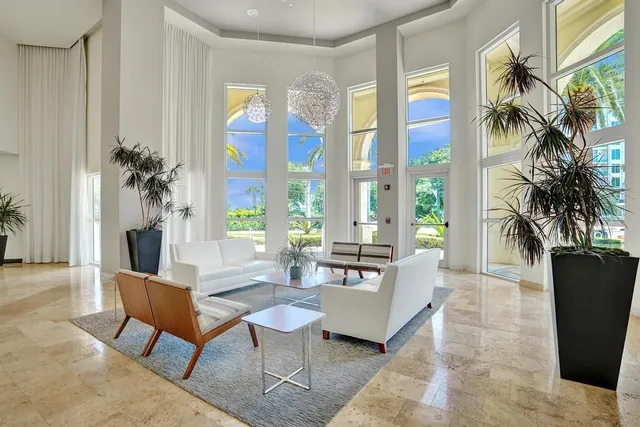 a living room with furniture a table and a potted plant