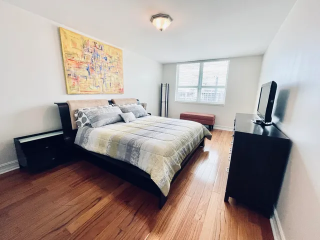 a spacious bathroom with a tub sink and a mirror