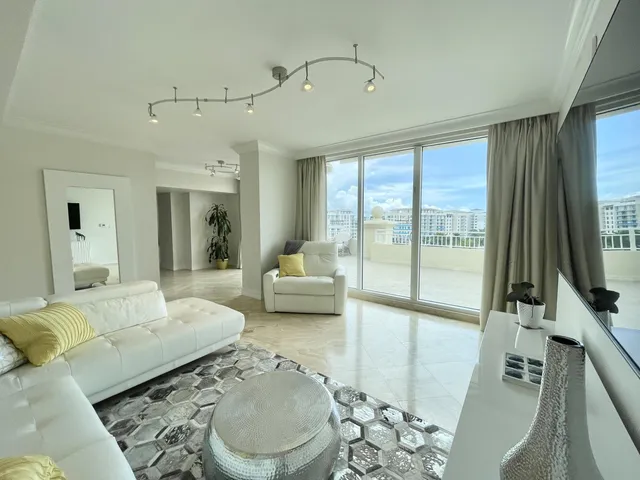 a kitchen with stainless steel appliances granite countertop a stove top oven a sink dishwasher a dining table and chairs with wooden floor