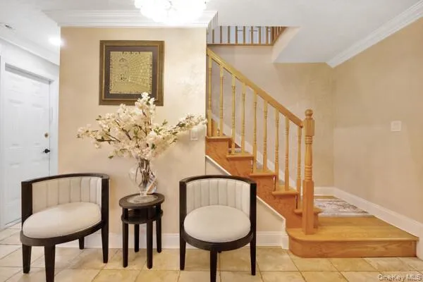 a view of a hallway with couches and a chandelier
