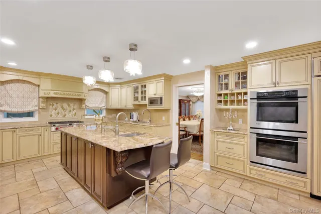 a kitchen with cabinets and chairs