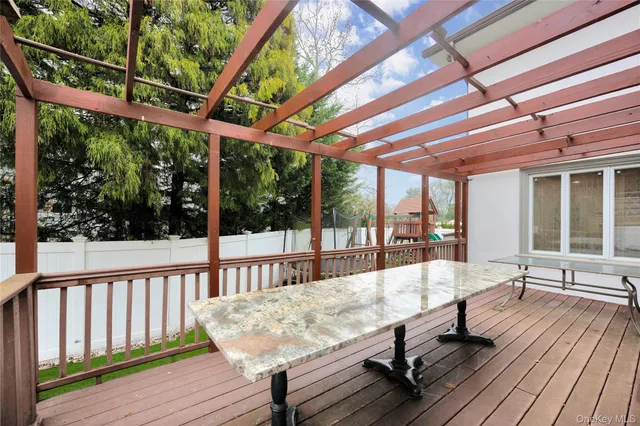 a view of a balcony with wooden floor and outdoor space