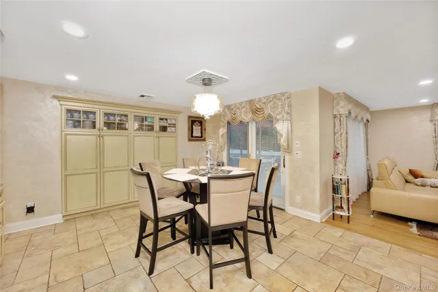a view of a dining room with furniture and chandelier