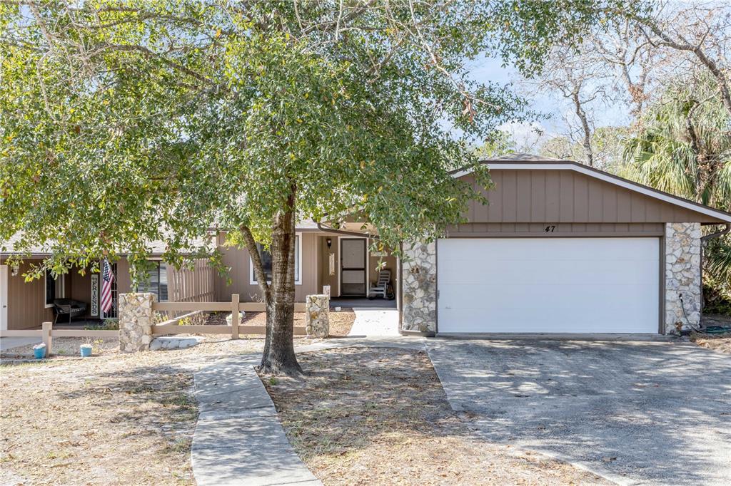 47 Crooked Pine Road Port Orange, FL 32128 - Photo 1 of 41 a house with trees in the background
