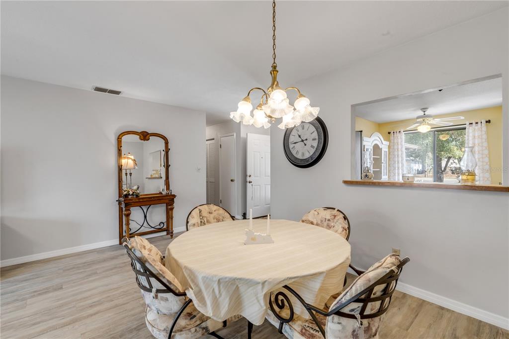 47 Crooked Pine Road Port Orange, FL 32128 - Photo 12 of 41 a view of a dining room with furniture wooden floor and chandelier