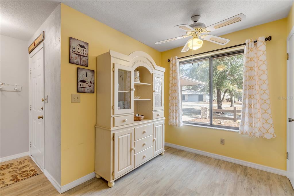 47 Crooked Pine Road Port Orange, FL 32128 - Photo 14 of 41 a view of an entryway with wooden floor and a ceiling fan