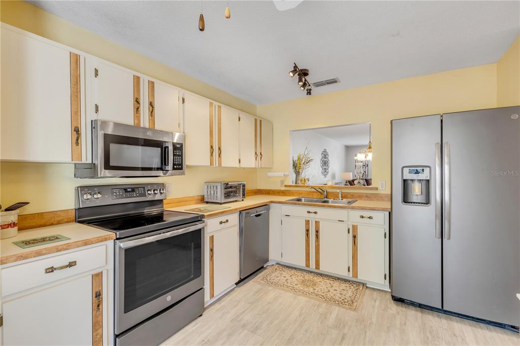 47 Crooked Pine Road Port Orange, FL 32128 - Photo 17 of 41 a kitchen with a sink stove and refrigerator