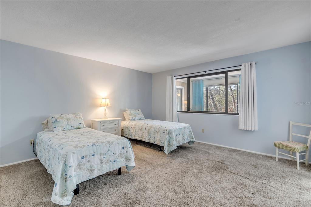 47 Crooked Pine Road Port Orange, FL 32128 - Photo 18 of 41 a bedroom with two beds and a window