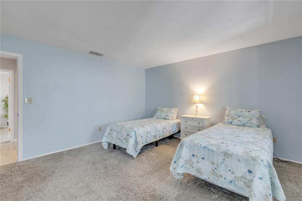 47 Crooked Pine Road Port Orange, FL 32128 - Photo 19 of 41 a bedroom with two beds and a night stand