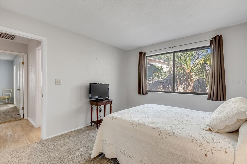 47 Crooked Pine Road Port Orange, FL 32128 - Photo 25 of 41 a bedroom with a large bed and a flat tv screen on dresser