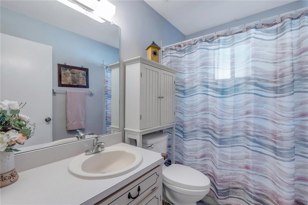 47 Crooked Pine Road Port Orange, FL 32128 - Photo 26 of 41 a bathroom with a sink a toilet and shower curtain
