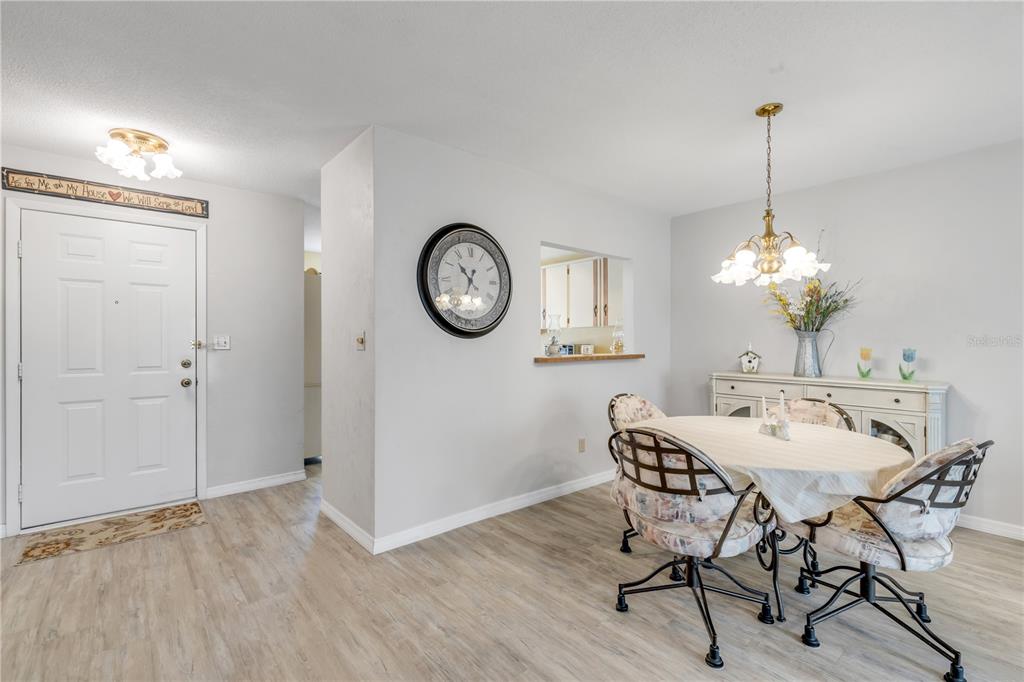 47 Crooked Pine Road Port Orange, FL 32128 - Photo 5 of 41 a view of a dining room with furniture a chandelier and wooden floor