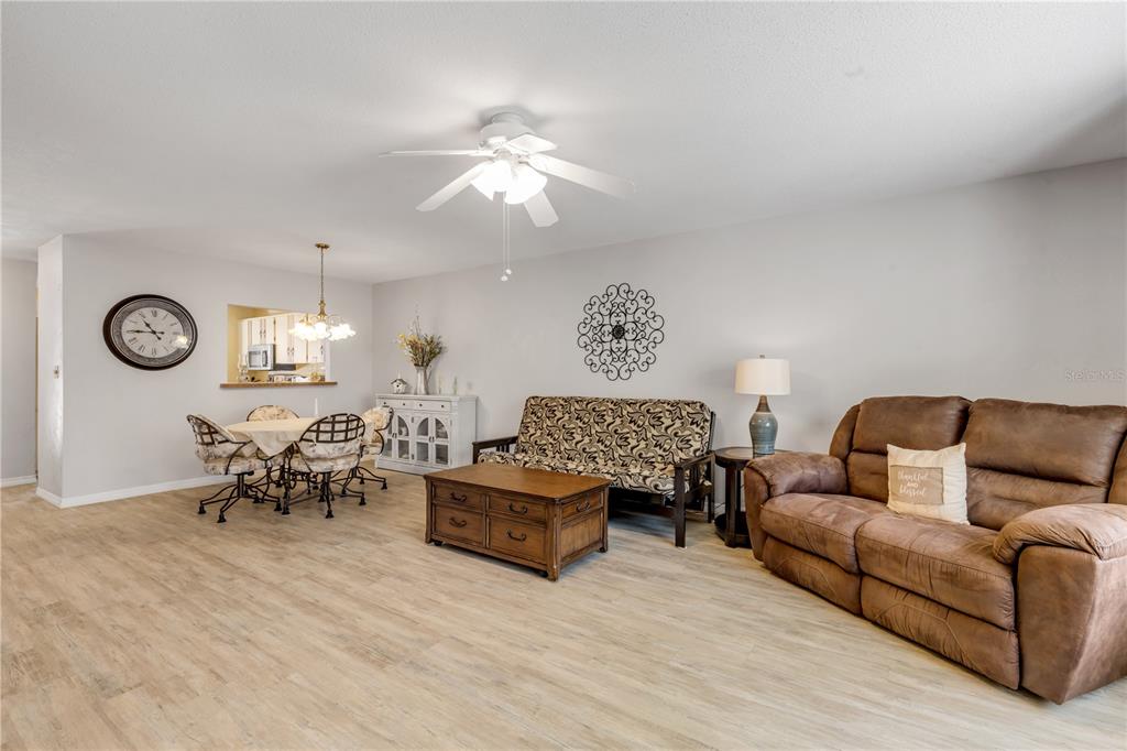 47 Crooked Pine Road Port Orange, FL 32128 - Photo 8 of 41 a living room with furniture a rug and a chandelier