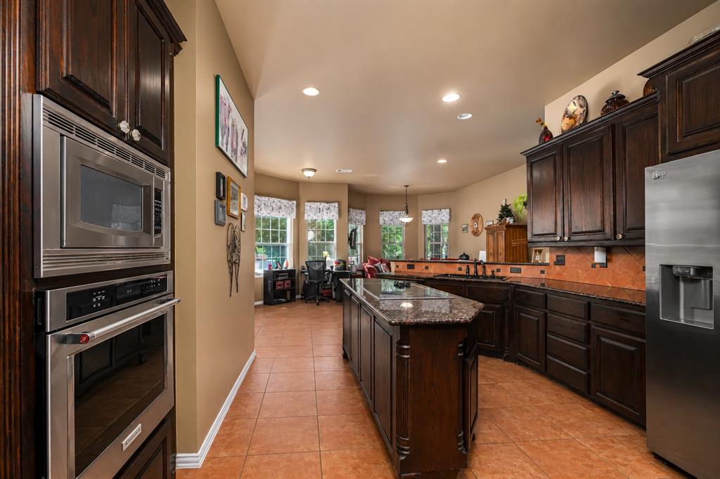 100 Manders Court Runaway Bay, TX 76426 - Photo 9 of 33 a kitchen with counter top space stainless steel appliances and cabinets