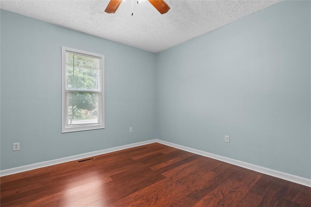 1423 Beulah Church Road Carrollton, GA 30117 - Photo 15 of 31 an empty room with wooden floor and windows