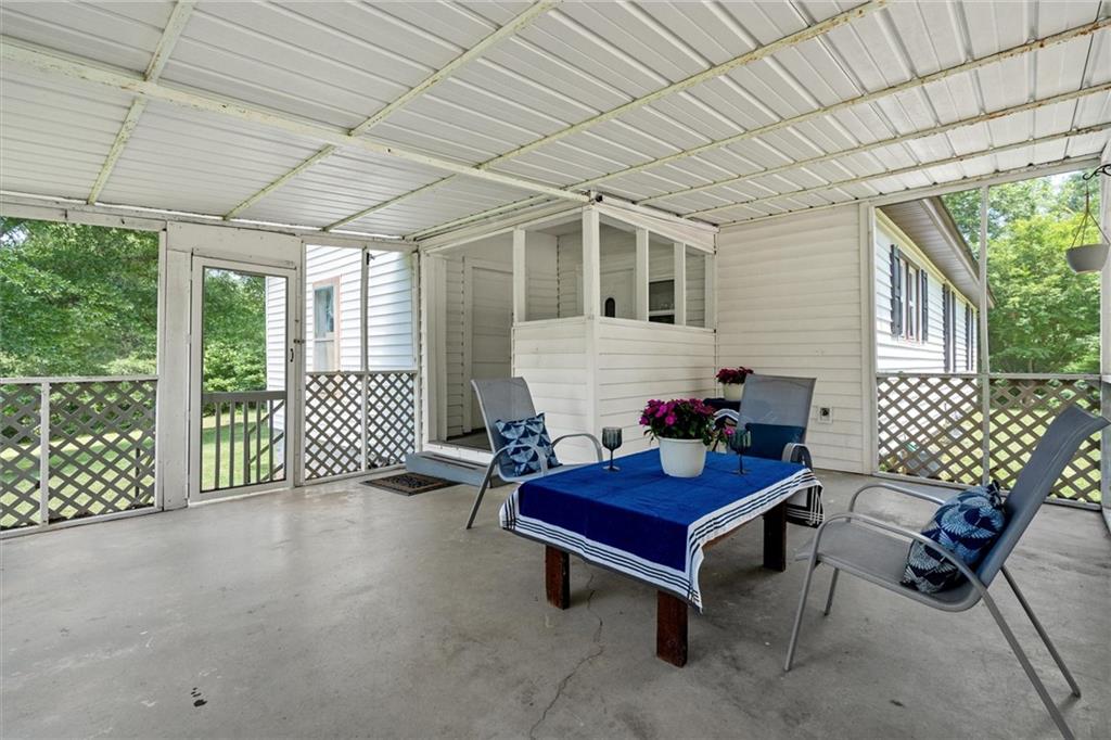 1423 Beulah Church Road Carrollton, GA 30117 - Photo 21 of 31 a outdoor living space with furniture and floor to ceiling window