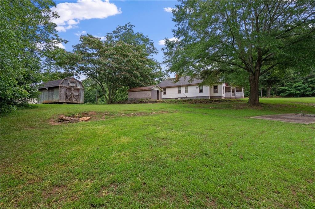1423 Beulah Church Road Carrollton, GA 30117 - Photo 27 of 31 a view of a house with a big yard and large trees