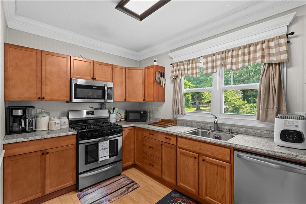 1423 Beulah Church Road Carrollton, GA 30117 - Photo 4 of 31 a kitchen with stainless steel appliances a sink stove and microwave