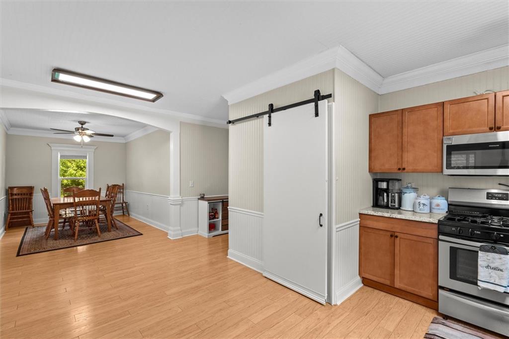 1423 Beulah Church Road Carrollton, GA 30117 - Photo 5 of 31 a kitchen with stainless steel appliances a refrigerator and a stove top oven