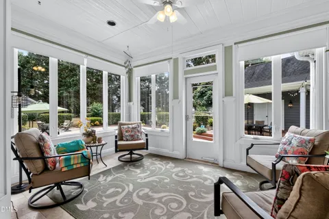 a living room with furniture and large windows