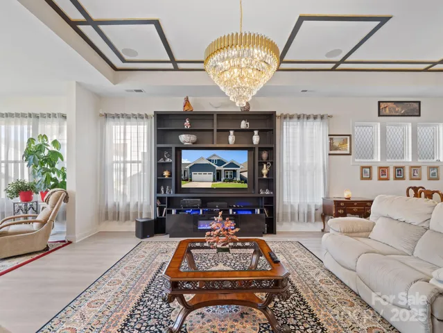 a living room with furniture and a chandelier