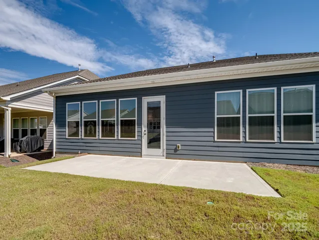 a view of a house with a large window and yard