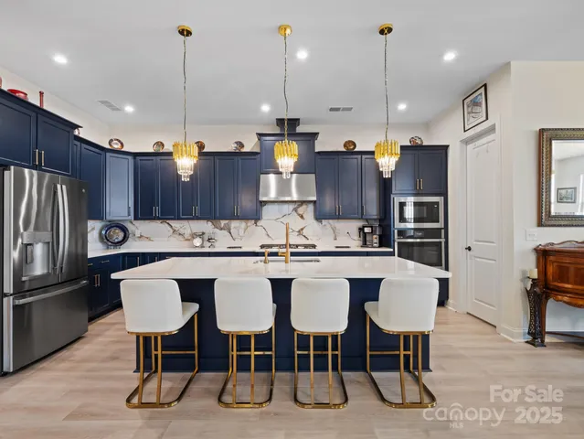 a large kitchen with a table and chairs