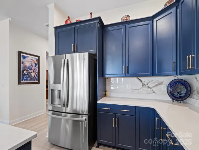 a kitchen with stainless steel appliances granite countertop a refrigerator and a sink