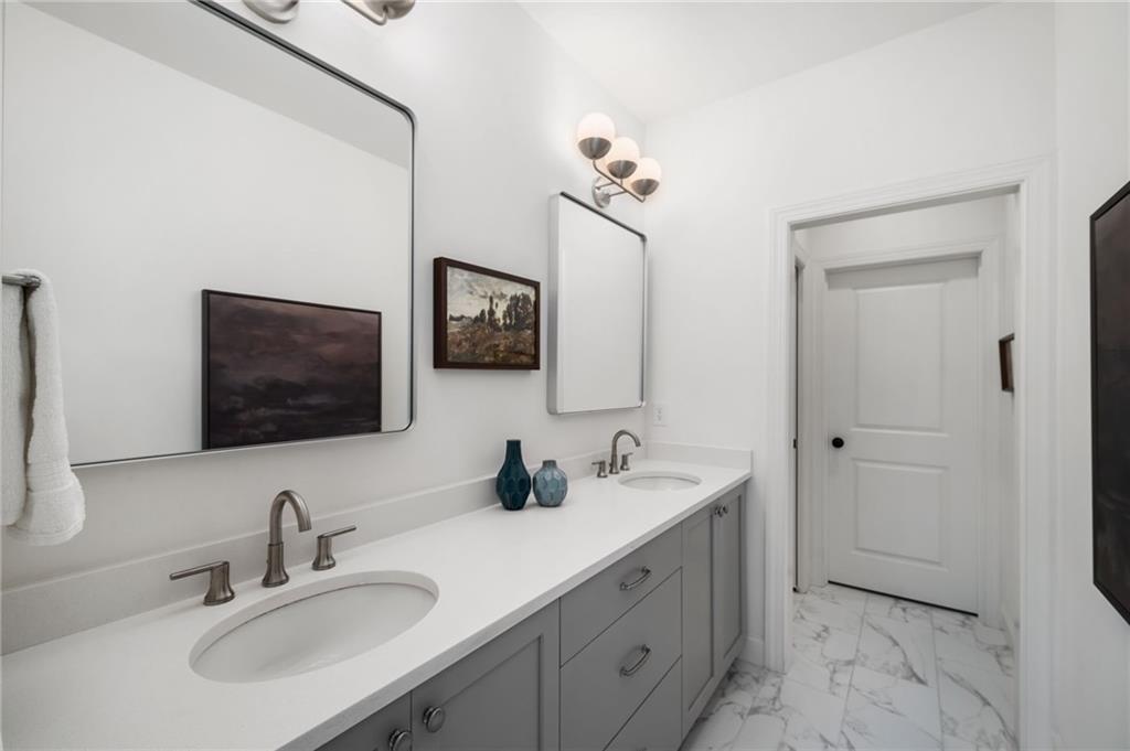 699 Eustace Street Southeast Atlanta, GA 30315 - Photo 27 of 54 a bathroom with double sink and a mirror