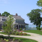 a front view of a house with a yard table and chairs