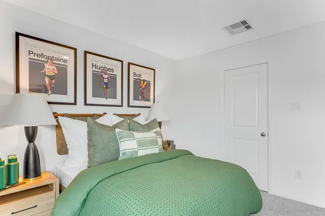 a bedroom with a bed and a large window