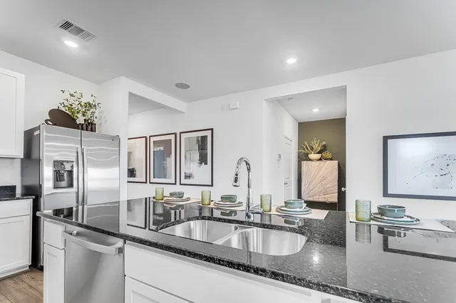a kitchen with counter top space and cabinets
