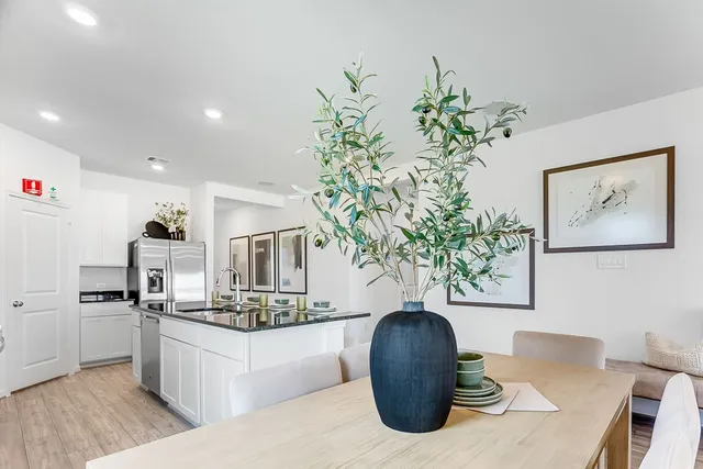 a living room with furniture potted plant and a flat screen tv