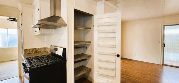 a kitchen with stainless steel appliances granite countertop a refrigerator and a stove