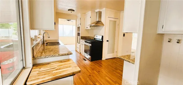 a view of a kitchen with wooden floor