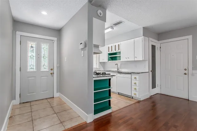 a kitchen with a stove a sink and a refrigerator