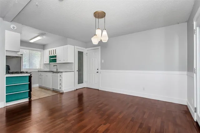 a view of kitchen with cabinets and wooden floor