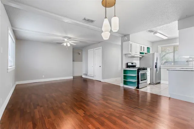 a view of kitchen with cabinets and wooden floor