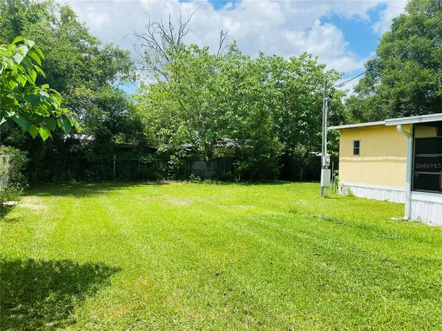 a backyard of a house with lots of green space