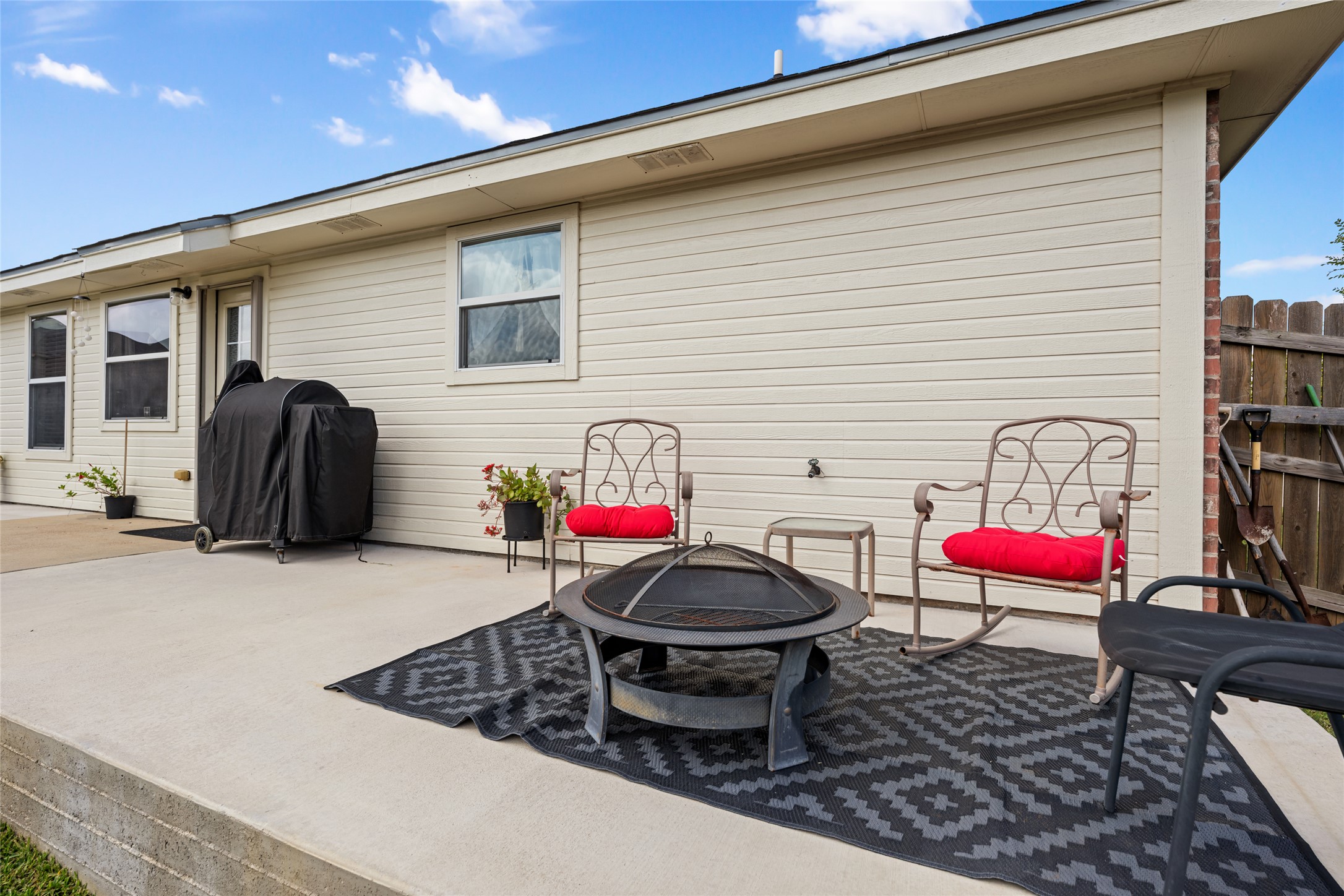 144 Calcite Lane Jarrell, TX 76537 - Photo 31 of 38 An inviting concrete patio provides ample space for relaxation and outdoor gatherings.