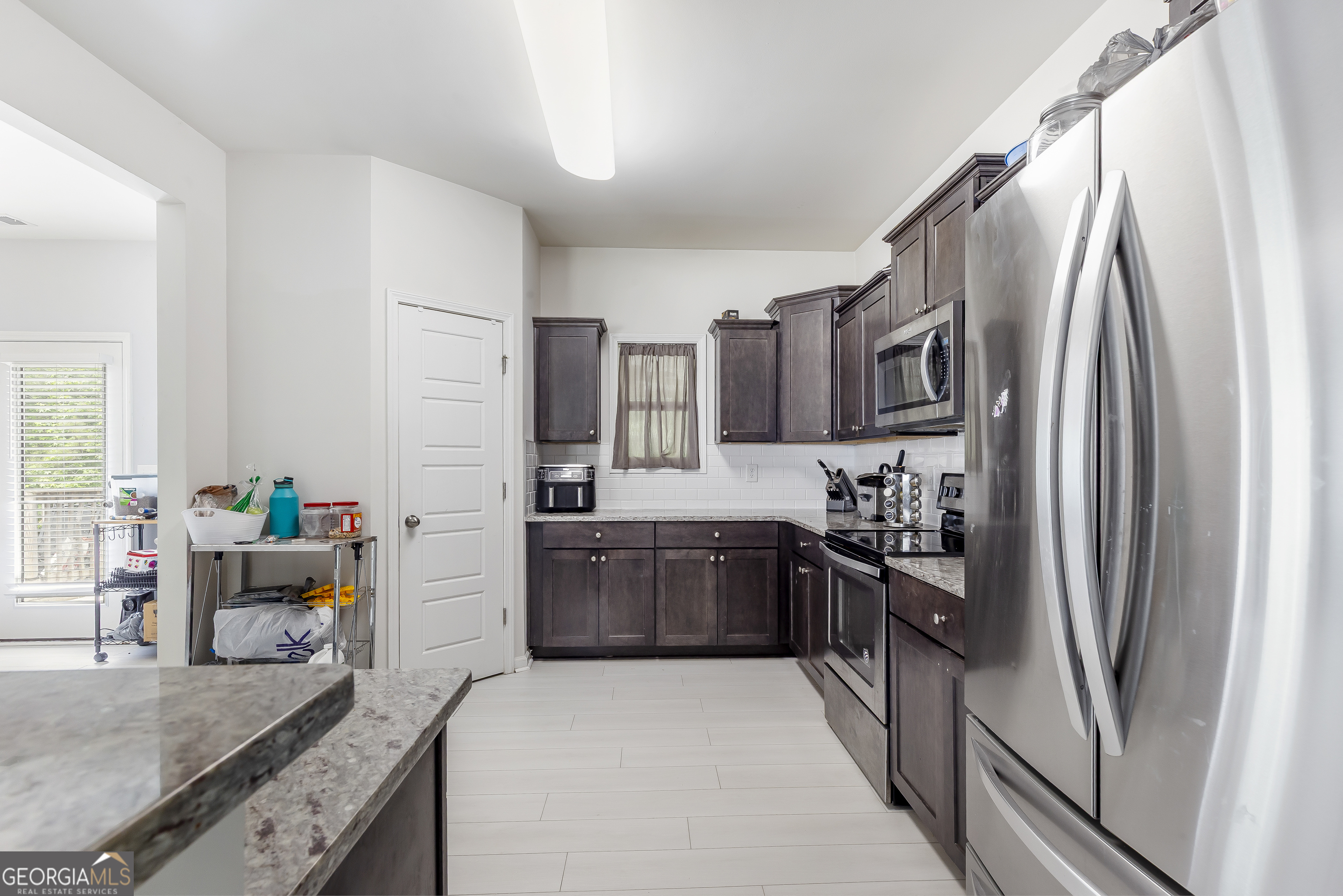 370 Springwater Way Bremen, GA 30110 - Photo 11 of 32 a kitchen with stainless steel appliances granite countertop a refrigerator stove and sink