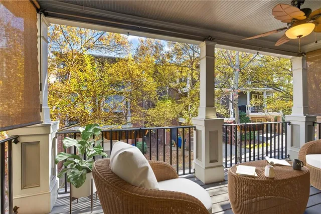 a balcony with furniture and a potted plant