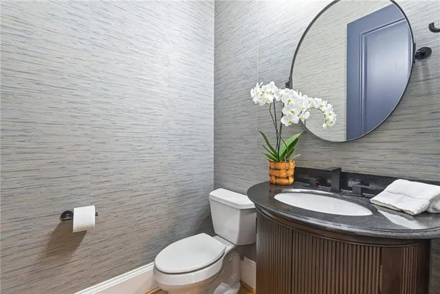 a bathroom with a sink a toilet and mirror