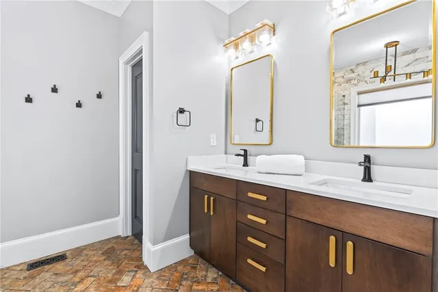 a bathroom with a double vanity sink and mirror
